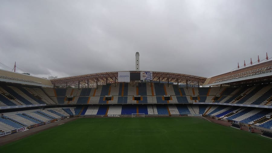 El estadio de Riazor, campo del Deportivo de La Coruña, con las gradas azules y blancas vacías bajo un cielo nublado